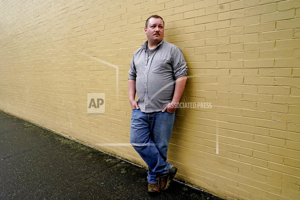 Elaine Thompson Nate Mullins, a former bartender from Oak, Harbor, Wash., who quit his job last November after clashing with managers over enforcing mask rules, poses for a photo Monday, May 17, 2021, in Mount Vernon, Wash. There's a wild card in the push to return to post-pandemic life: many workers don't want to return to the jobs they once had. Mullins' unemployment checks don't match what he was making at the bar, but they're enough to get by while he looks for jobs that would provide health care and retirement benefits. (AP Photo/Elaine Thompson)