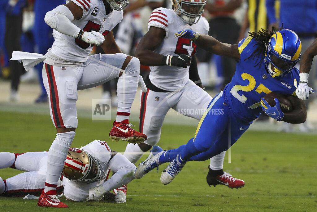 Jed Jacobsohn Los Angeles Rams running back Darrell Henderson Jr. (27) falls forward as he is tackled by San Francisco 49ers free safety Jimmie Ward, bottom left, during the first half of an NFL football game in Santa Clara, Calif., Sunday, Oct. 18, 2020. (AP Photo/Jed Jacobsohn)