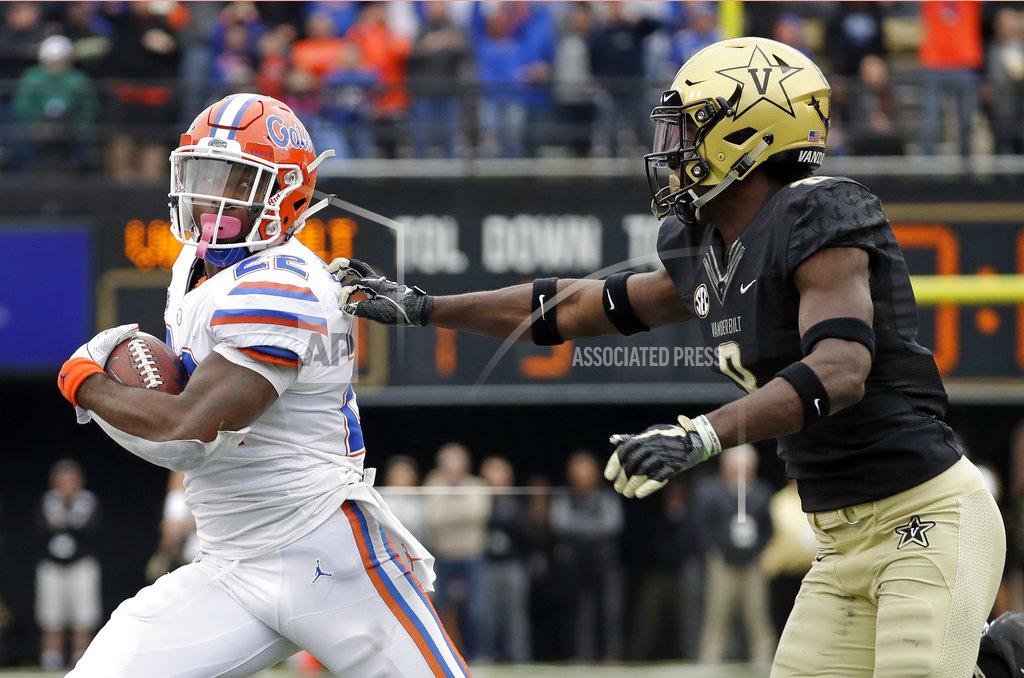 Mark Humphrey Florida running back Lamical Perine (22) carries the ball against Vanderbilt cornerback Joejuan Williams (8) in the first half of an NCAA college football game Saturday, Oct. 13, 2018, in Nashville, Tenn. (AP Photo/Mark Humphrey)