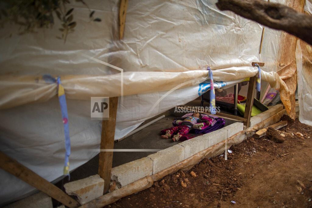 Hassan Ammar Syrian refugee Rayan, 18 months old, sleeps inside her parents' tent, at an informal refugee camp, in the town of Rihaniyye in the northern city of Tripoli, Lebanon, Thursday, April 8, 2021. For many Syrian refugee families in Lebanon, Ramadan comes as a hard life of displacement has gotten even harder after a pandemic year that deepened economic woes in their host country. (AP Photo/Hassan Ammar)