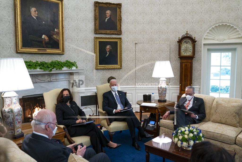 Evan Vucci President Joe Biden and Vice President Kamala Harris meet with Senate Majority Leader Sen. Chuck Schumer of N.Y., and other Democratic lawmakers to discuss a coronavirus relief package, in the Oval Office of the White House, Wednesday, Feb. 3, 2021, in Washington. (AP Photo/Evan Vucci)
