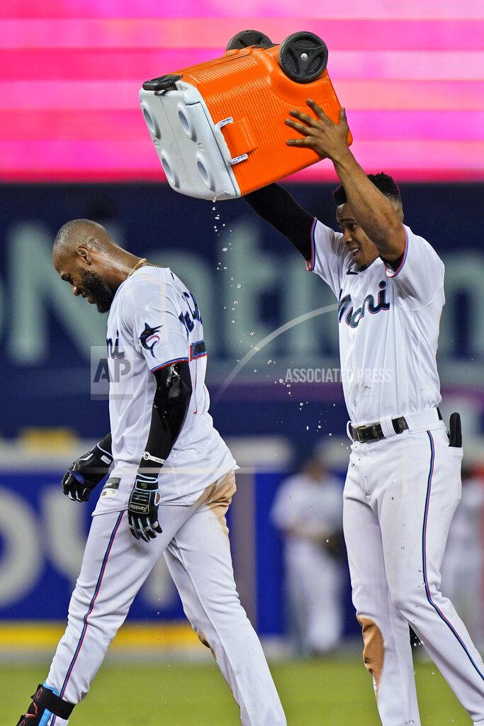 Wilfredo Lee Miami Marlins' Bryan De La Cruz, left, is doused with water by Magneuris Sierra after De La Cruz hit a single to drive in Jazz Chisholm Jr., giving the Marlins a 2-1 win over the New York Mets in 10 innings in a baseball game Wednesday, Sept. 8, 2021, in Miami. (AP Photo/Wilfredo Lee)