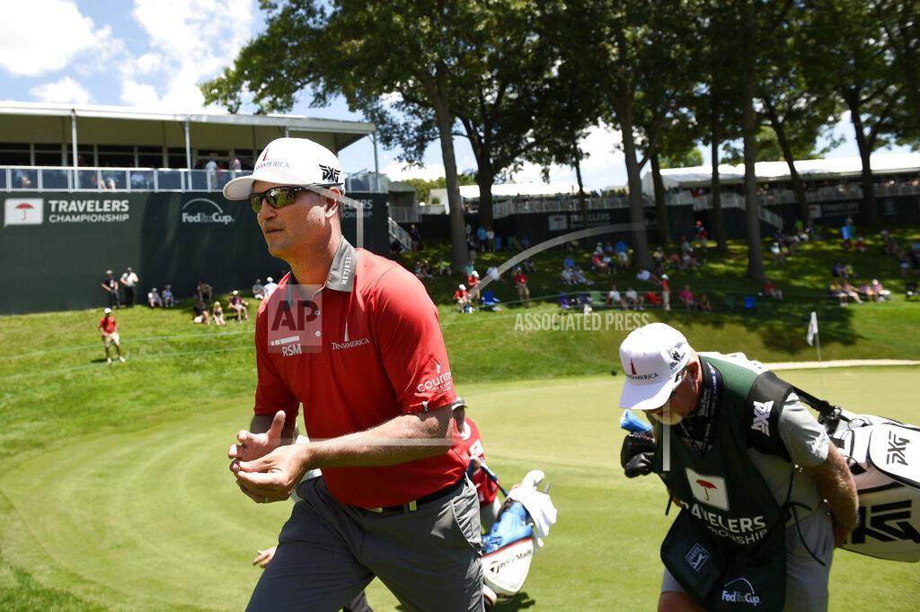 John Woike FILE - In this June 21, 2018, file photo, Zach Johnson walks off the 18th green during the first round of the Travelers Championship at TPC River Highlands in Cromwell, Conn. The tournament director for this week's Travelers Championship thought about encircling the 18th green at TPC River Highlands with giant video boards that could be filled with images of fans watching the golf and cheering from home. Thursday's, June 25, 2020, tournament will be held without fans, but is still expected to raise significant funds for charity. (John Woike/Hartford Courant via AP, File)