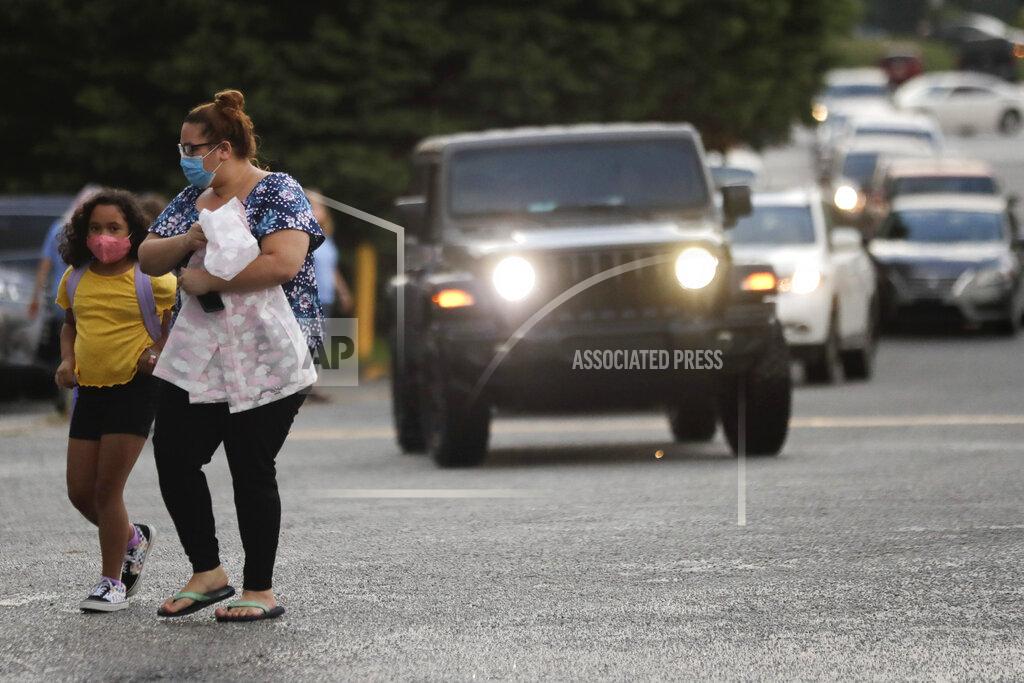 Brynn Anderson Students arrive to Dallas Elementary School for the first day of school amid the coronavirus outbreak on Monday, Aug. 3, 2020, in Dallas, Ga. (AP Photo/Brynn Anderson)