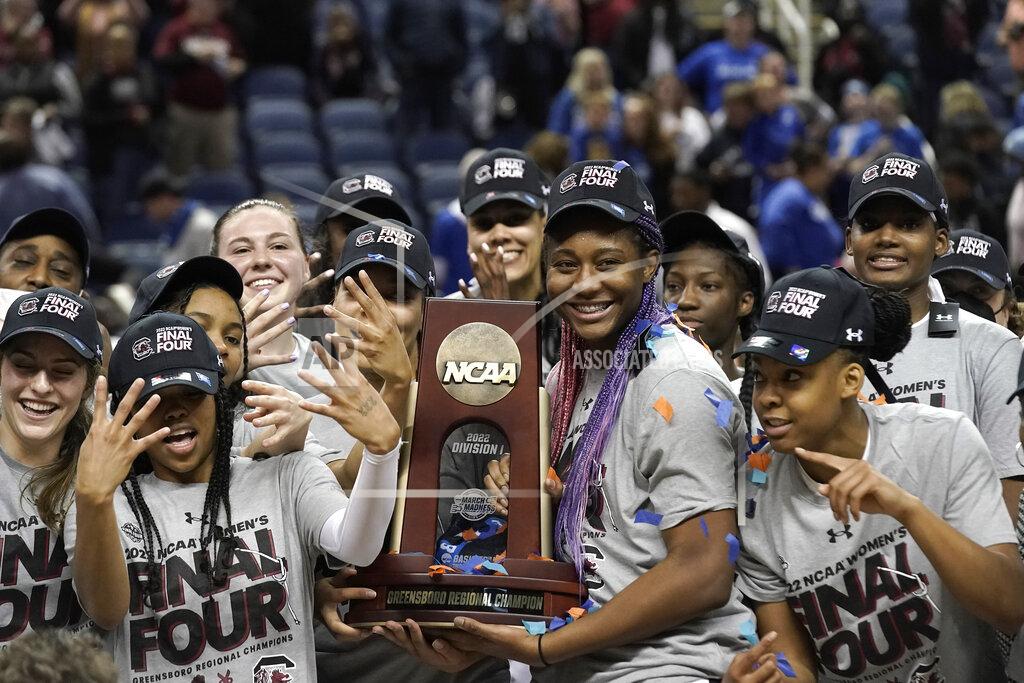 Gerry Broome South Carolina players hold the trophy following a college basketball game against Creighton in the Elite 8 round of the NCAA tournament in Greensboro, N.C., Sunday, March 27, 2022. (AP Photo/Gerry Broome)