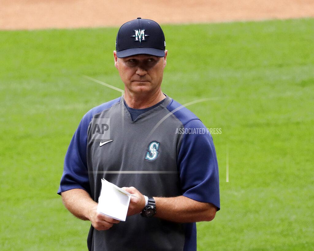 Elaine Thompson FILE - In this July 3, 2020, file photo, Seattle Mariners manager Scott Servais walks on the field at a "summer camp" baseball workout on their ballpark field in Seattle. MLB pitchers are eager to fire some fastballs and spin a few breaking balls now that a semi-normal spring training has started. Coaches and executives are trying to make sure everyone stays healthy. (AP Photo/Elaine Thompson, File)