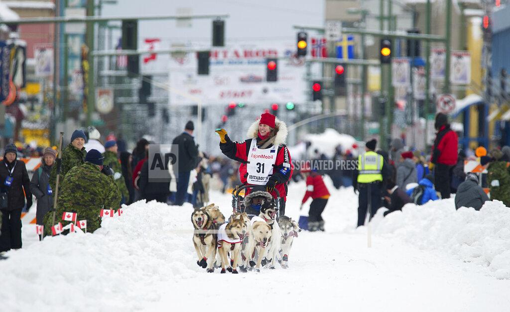 FILE - In this March 3, 2018, file photo, musher Aliy Zirkle runs her team during the ceremonial start of the Iditarod Trail Sled Dog Race in Anchorage, Alaska. There has been another dramatic change to the world’s most famous sled dog race this year because of the pandemic, with officials announcing Friday, Feb. 5, 2021, that the ceremonial start has been canceled. (AP Photo/Michael Dinneen, File)