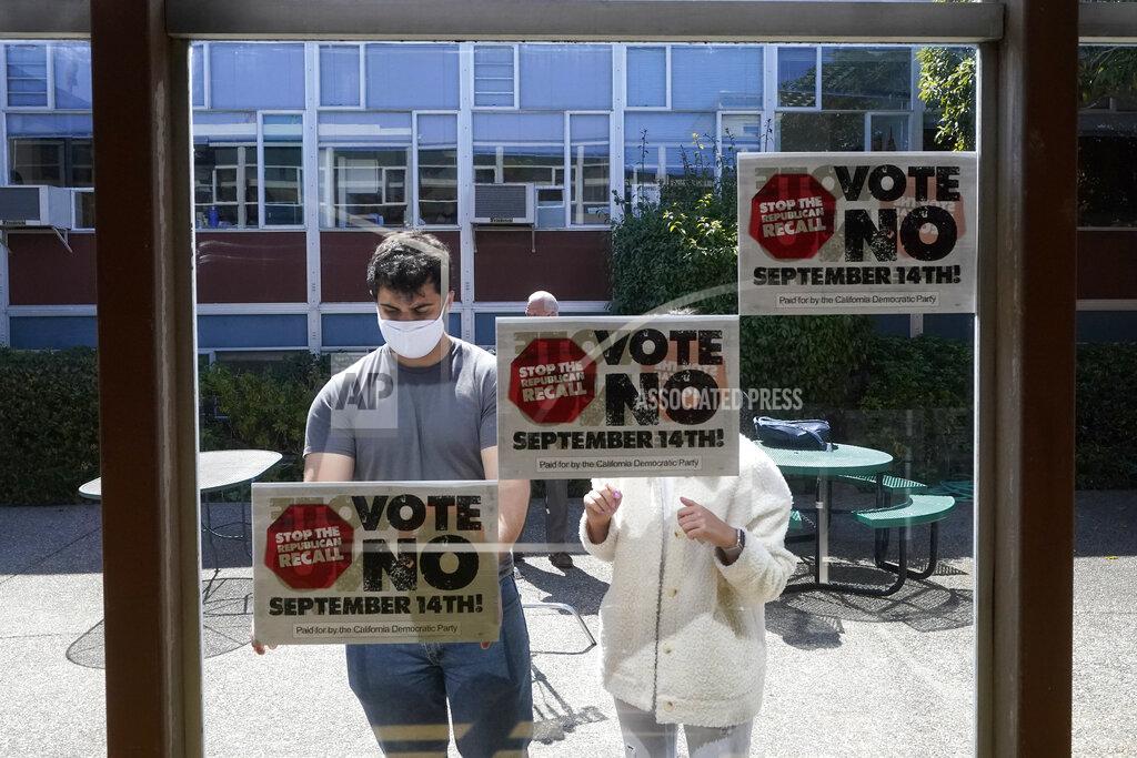 Jeff Chiu Volunteers put up signs to Vote No on recalling Gov. Gavin Newsom in San Francisco, Tuesday, Sept. 14, 2021. The recall election that could remove California Democratic Gov. Newsom is coming to an end. Voting concludes Tuesday in the rare, late-summer election that has emerged as a national battlefront on issues from COVID-19 restrictions to climate change. (AP Photo/Jeff Chiu)