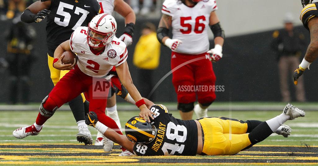 Charlie Neibergall Nebraska quarterback Adrian Martinez (2) breaks a tackle by Iowa linebacker Jack Hockaday (48) during the second half of an NCAA college football game, Friday, Nov. 23, 2018, in Iowa City, Iowa. Iowa won 31-28. (AP Photo/Charlie Neibergall)