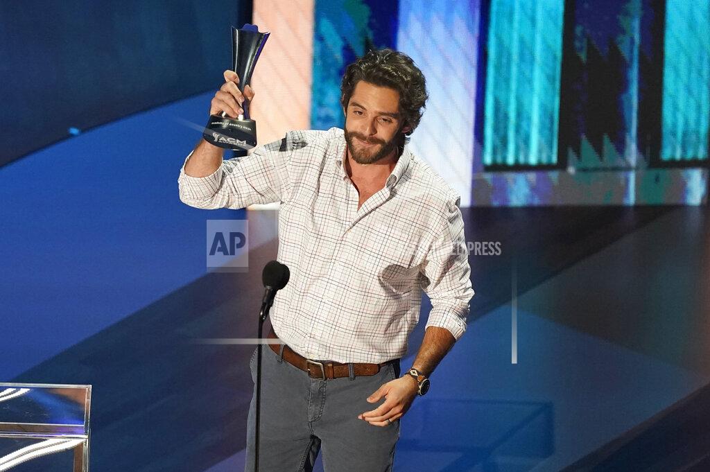 Mark Humphrey Thomas Rhett accepts the entertainer of the year award in a tie with Carrie Underwood during the 55th annual Academy of Country Music Awards at the Grand Ole Opry House on Wednesday, Sept. 16, 2020, in Nashville, Tenn. (AP Photo/Mark Humphrey)