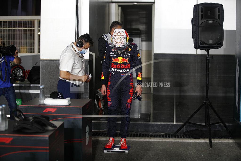 Hamad I Mohammed Red Bull driver Max Verstappen of the Netherlands stand on a scale after qualifying session qualifying session in Lusail, Qatar, Saturday, Nov. 20, 2021 ahead of the Qatar Formula One Grand Prix. (Hamad I Mohammed, Pool via AP)