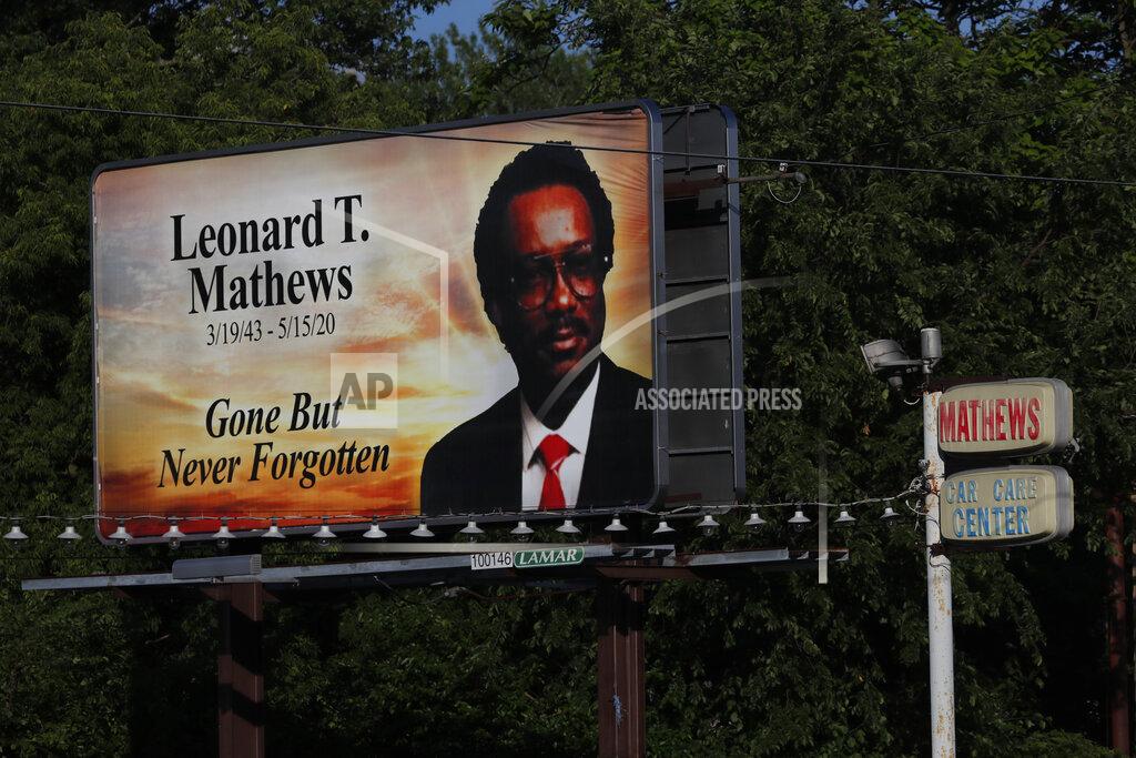 Charles Rex Arbogast A billboard remembering Leonard T. Mathews, who people say was a pillar of the community in the impoverished east side of Saginaw, Mich., stands next to the business sign of his former car care service on Monday, June 29, 2020. (AP Photo/Charles Rex Arbogast)
