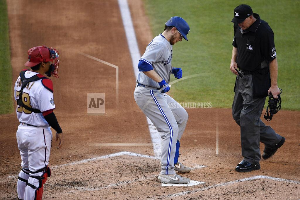 Nick Wass Toronto Blue Jays' Danny Jansen, center, steps on the plate after his home run as Washington Nationals catcher Kurt Suzuki watches during the fourth inning of a baseball game Monday, July 27, 2020, in Washington. (AP Photo/Nick Wass)