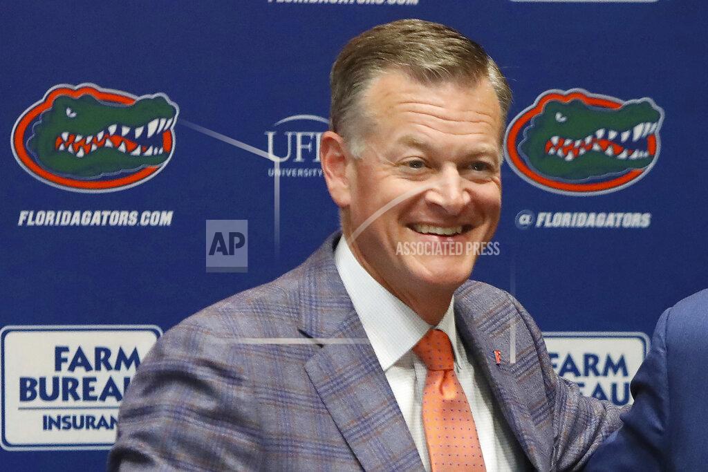 Brad Mcclenny FILE - Univ. of Florida athletic director Scott Stricklin smiles during a news conference at Ben Hill Griffin Stadium in Gainesville, Fla., Sunday, Dec. 5, 2021. By trying to limit how much schools can help college athletes cashing in on their fame, the NCAA seems to have inadvertently opened the door for boosters to take hold of a burgeoning market. Stricklin said he and his staff communicate with the collectives working on behalf of Florida and are confident they are working within the rules. However, highlighting the line between what is and is not allowed with boosters and NIL is far easier than policing it. (Brad McClenny/The Gainesville Sun via AP, File)