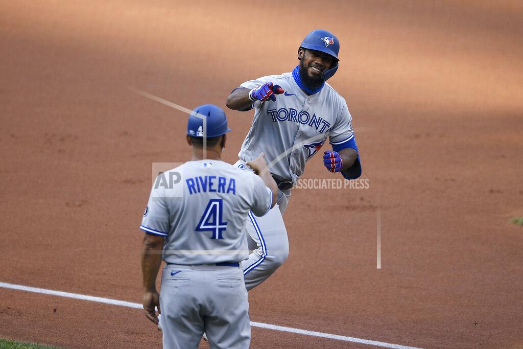Nick Wass Toronto Blue Jays' Teoscar Hernandez, right, celebrates his home run with third base coach Luis Rivera (4) during the first inning of the team's baseball game against the Washington Nationals, Monday, July 27, 2020, in Washington. (AP Photo/Nick Wass)