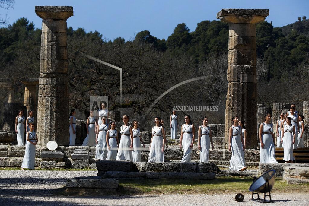 Thanassis Stavrakis Actresses, playing the role of priestesses, performance during the flame lighting ceremony at the closed Ancient Olympia site, birthplace of the ancient Olympics in southern Greece, Thursday, March 12, 2020. Greek Olympic officials are holding a pared-down flame-lighting ceremony for the Tokyo Games due to concerns over the spread of the coronavirus. Both Wednesday's dress rehearsal and Thursday's lighting ceremony are closed to the public, while organizers have slashed the number of officials from the International Olympic Committee and the Tokyo Organizing Committee, as well as journalists at the flame-lighting. (AP Photo/Thanassis Stavrakis)