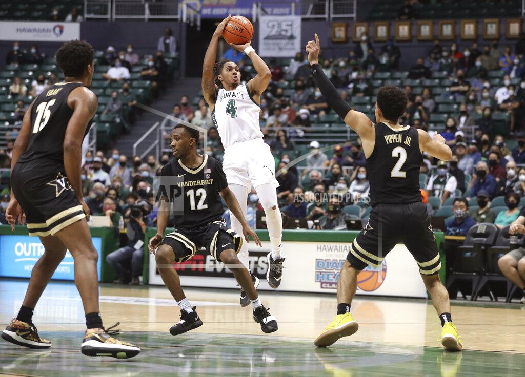 Marco Garcia Hawaii guard Noel Coleman (4) shoots over the Vanderbilt defense in the second half of an NCAA college basketball game Wednesday, Dec. 22, 2021, in Honolulu. (AP Photo/Marco Garcia)