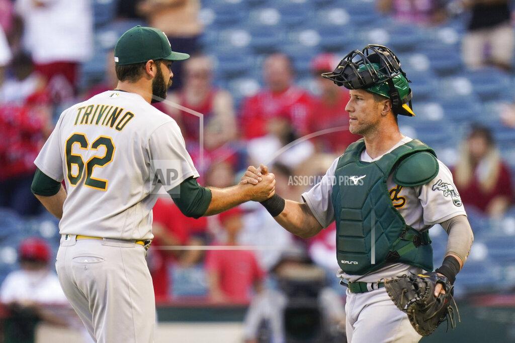 Jae C. Hong Oakland Athletics relief pitcher Lou Trivino, left, and catcher Yan Gomes celebrate a win in the 10th inning of a baseball game against the Los Angeles Angels, Sunday, Sept. 19, 2021, in Anaheim, Calif. (AP Photo/Jae C. Hong)
