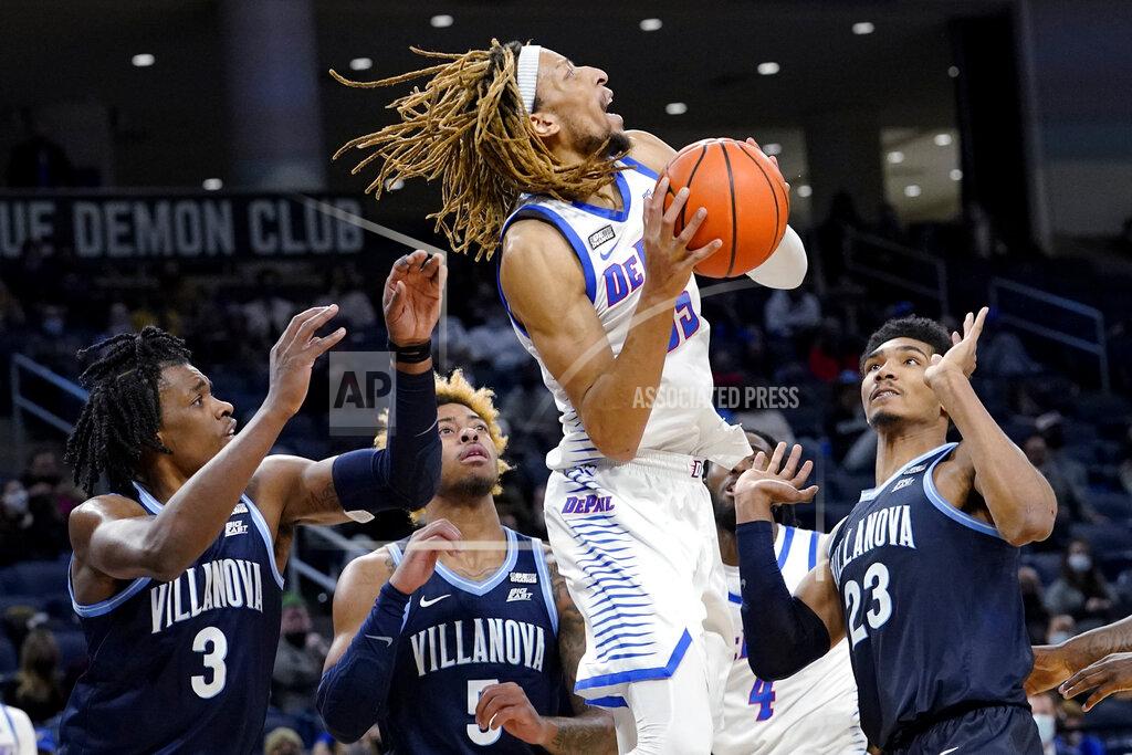 Nam Y. Huh DePaul forward Brandon Johnson, second from right, goes up for a shot against Villanova forward Brandon Slater, left, guard Justin Moore, and forward Jermaine Samuels, right, during the second half of an NCAA college basketball game in Chicago, Saturday, Jan. 8, 2022. Villanova won 79-64. (AP Photo/Nam Y. Huh)