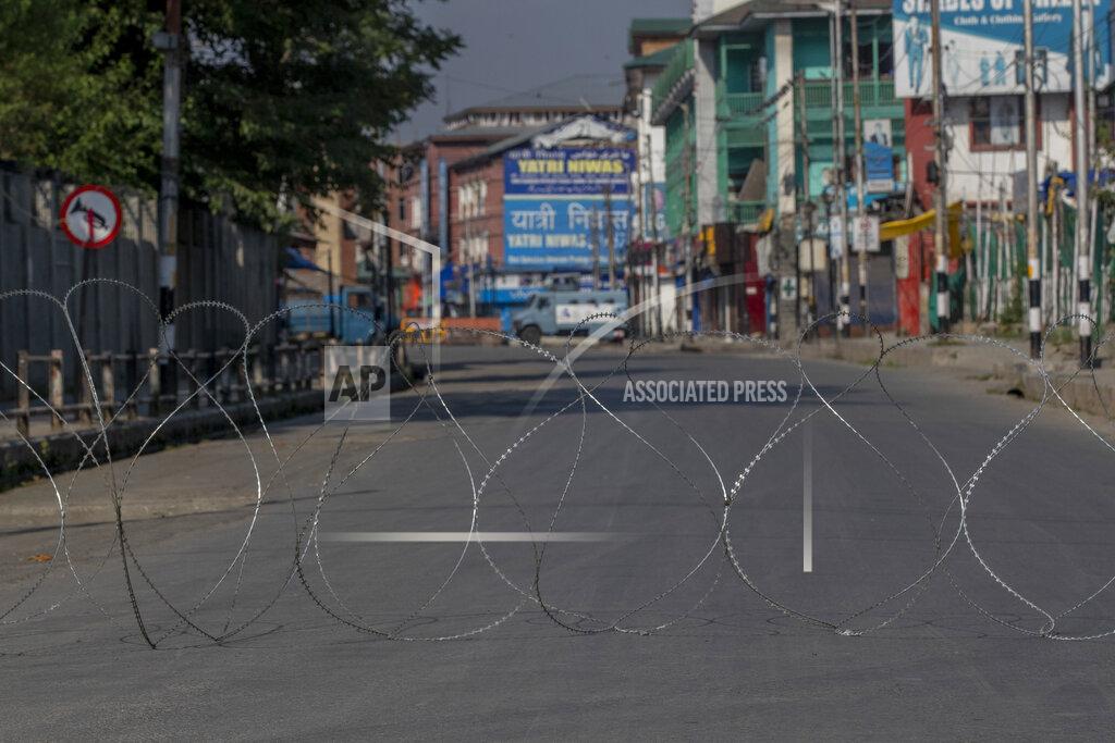 Dar Yasin A barbwire blocks a deserted street on the first anniversary of India’s decision to revoke the disputed region’s semi-autonomy, in Srinagar, Indian controlled Kashmir, Wednesday, Aug. 5, 2020. Last year on Aug. 5, India’s Hindu-nationalist-led government of Prime Minister Narendra Modi stripped Jammu-Kashmir of its statehood and divided it into two federally governed territories. Late Tuesday, authorities lifted a curfew in Srinagar but said restrictions on public movement, transport and commercial activities would continue because of the coronavirus pandemic. (AP Photo/ Dar Yasin)