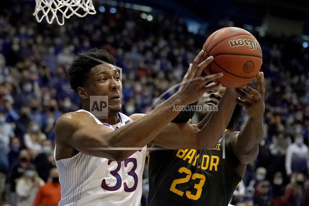Charlie Riedel Kansas forward David McCormack (33) and Baylor forward Jonathan Tchamwa Tchatchoua (23) chase after a rebound during the first half of an NCAA college basketball game Saturday, Feb. 5, 2022, in Lawrence, Kan. (AP Photo/Charlie Riedel)