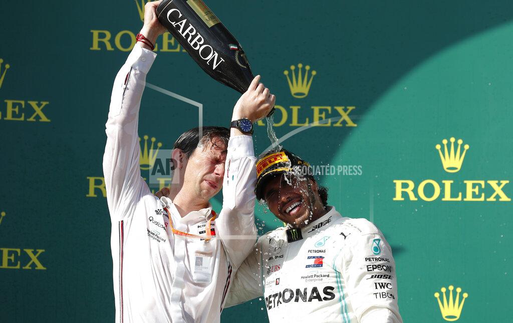 Laszlo Balogh Mercedes driver Lewis Hamilton, right, of Britain, celebrates on the podium with a member of his team after winning the Hungarian Formula One Grand Prix at the Hungaroring racetrack in Mogyorod, northeast of Budapest, Hungary, Sunday, Aug. 4, 2019. (AP Photo/Laszlo Balogh)