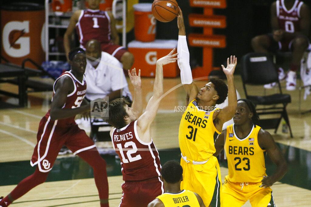Ray Carlin Baylor guard MaCio Teague (31) is called for the foul as he gets a hand on the shot of Oklahoma guard Austin Reaves (12) during the second half of an NCAA college basketball game on Wednesday, Jan. 6, 2021, in Waco, Texas. (AP Photo/Ray Carlin)