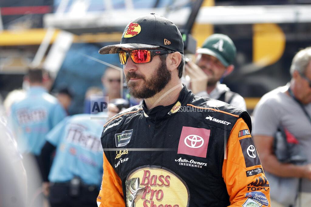 Gerry Broome Martin Truex Jr. walks past fans during practice for Sunday's NASCAR Cup Series auto race at Charlotte Motor Speedway in Concord, N.C., Saturday, Sept. 28, 2019. (AP Photo/Gerry Broome)