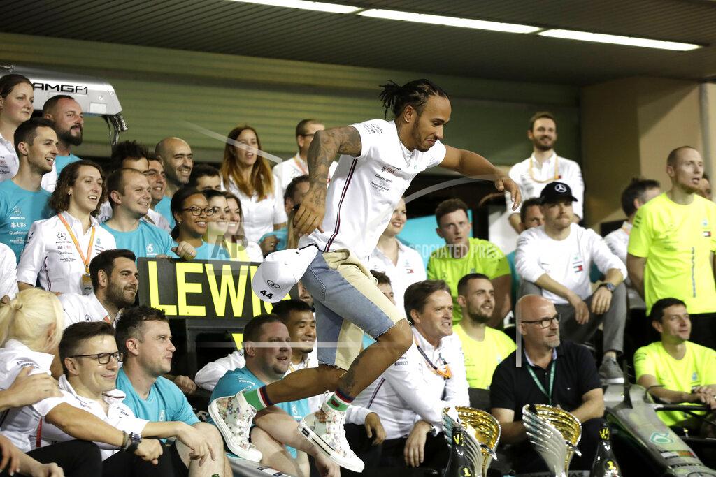 Luca Bruno Mercedes driver Lewis Hamilton of Britain celebrates in the garage after winning the Emirates Formula One Grand Prix, at the Yas Marina racetrack in Abu Dhabi, United Arab Emirates, Sunday, Dec.1, 2019. (AP Photo/Luca Bruno)