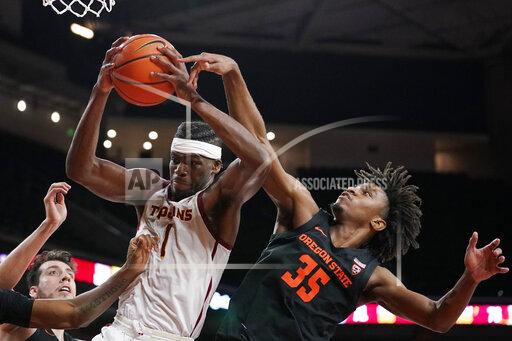 Southern California forward Chevez Goodwin, left, grabs a rebound away from Oregon State forward Glenn Taylor Jr. during the second half of an NCAA college basketball game Thursday, Jan. 13, 2022, in Los Angeles. (AP Photo/Mark J. Terrill)