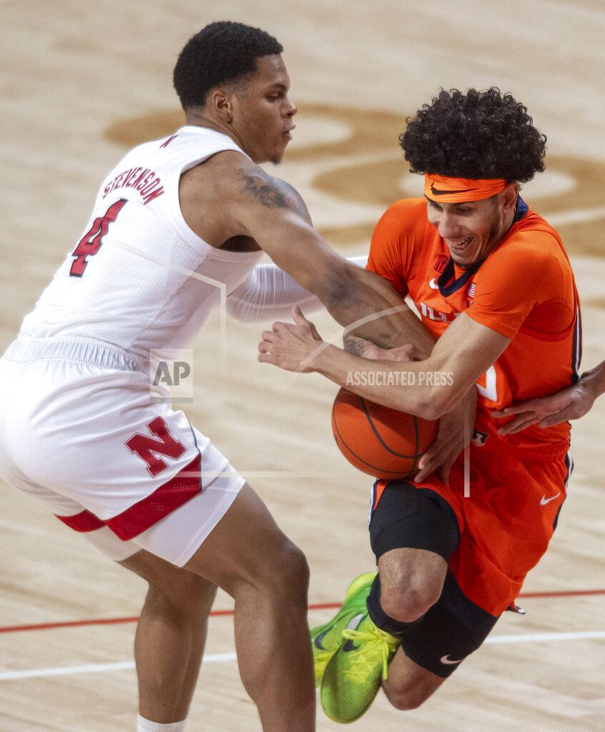 Francis Gardler Nebraska guard Shamiel Stevenson (4) reaches in for the ball against Illinois' Andre Curbelo (5) during the first half of an NCAA college basketball game on Friday, Feb. 12, 2021, in Lincoln, Neb. (Francis Gardler/Lincoln Journal Star via AP)