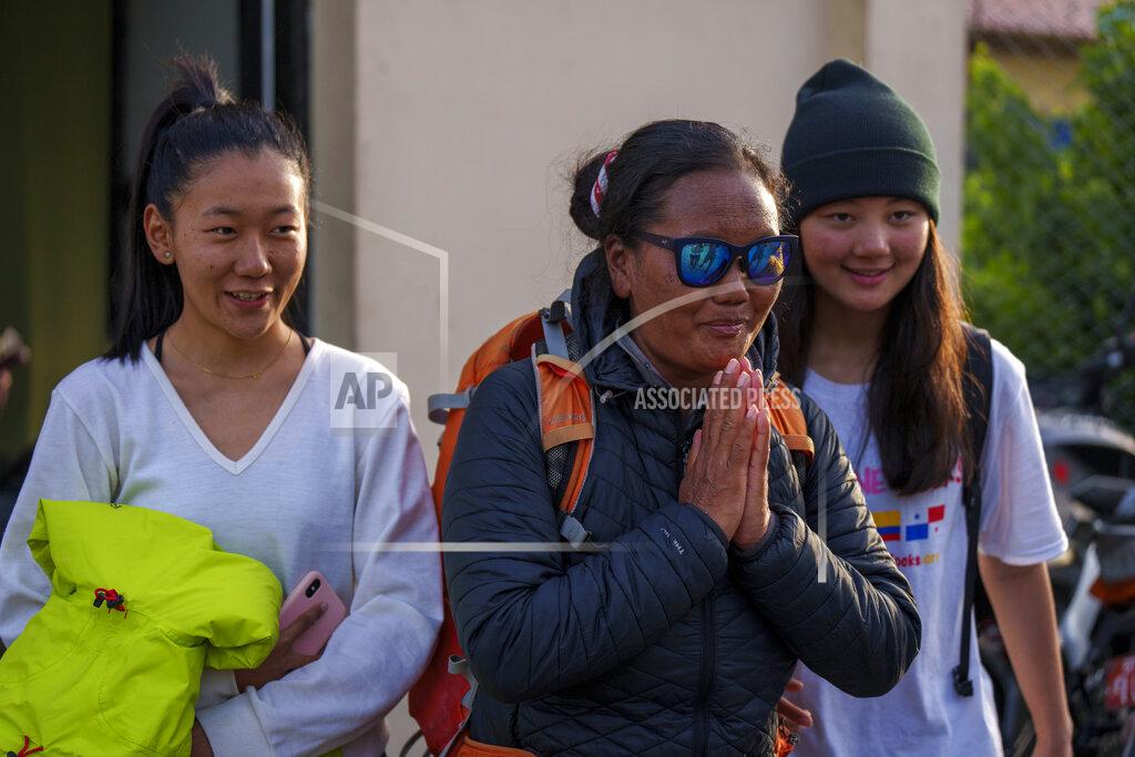 Niranjan Shrestha Nepalese climber Lhakpa Sherpa gestures as she arrives at the airport in Kathmandu, Nepal, Tuesday, May 17, 2022. The Nepali Sherpa broke her own record reaching the 8,849-meter (29,032-foot) summit for a 10th time — the most times any woman has climbed Mount Everest. Sherpa, 48, said she is next planning to scale the world's second-highest peak, K2 in Pakistan. (AP Photo/Niranjan Shrestha)