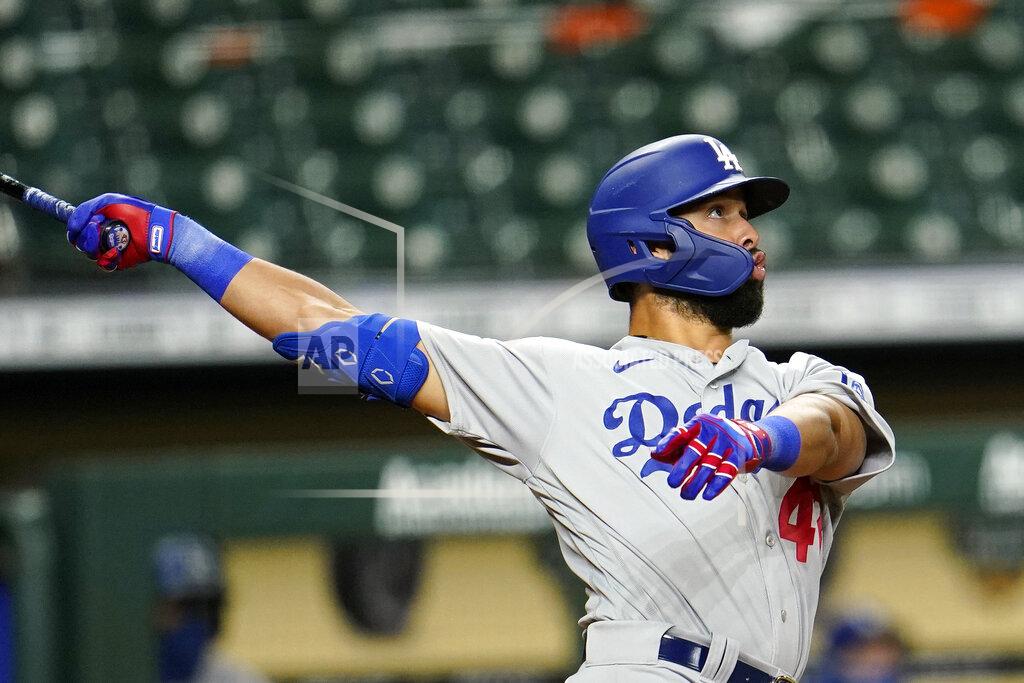 David J. Phillip Los Angeles Dodgers' Edwin Rios watches his two-run home run against the Houston Astros during the 13th inning of a baseball game Wednesday, July 29, 2020, in Houston. The Dodgers won 4-2 in 13 innings. (AP Photo/David J. Phillip)