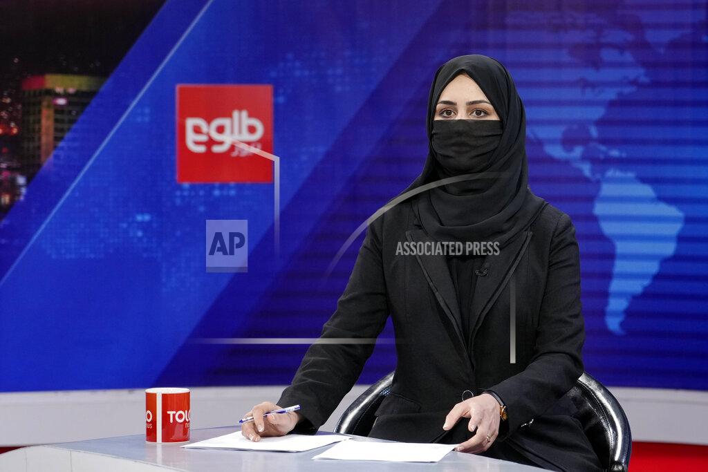 Ebrahim Noroozi Khatereh Ahmadi a TV anchor wears a face covering as she reads the news on TOLO NEWS, in Kabul, Afghanistan, Sunday, May 22, 2022. Afghanistan's Taliban rulers have begun enforcing an order requiring all female TV news anchors in the country to cover their faces while on-air. The move Sunday is part of a hard-line shift drawing condemnation from rights activists. (AP Photo/Ebrahim Noroozi)