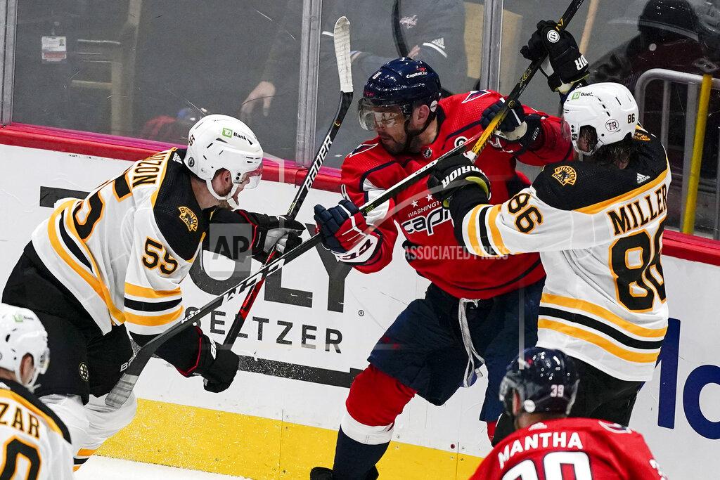 Alex Brandon Boston Bruins defensemen Jeremy Lauzon (55) and Kevan Miller (86) combine to defend against Washington Capitals left wing Alex Ovechkin (8) during the second period of Game 1 of an NHL hockey Stanley Cup first-round playoff series Saturday, May 15, 2021, in Washington. (AP Photo/Alex Brandon)