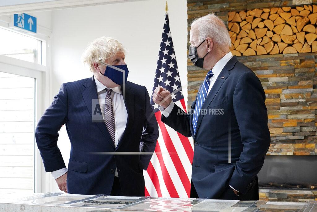 Patrick Semansky President Joe Biden and British Prime Minister Boris Johnson talk as they look over copies of the Atlantic Charter, during a bilateral meeting ahead of the G-7 summit, Thursday, June 10, 2021, in Carbis Bay, England.The Atlantic Charter is a copy of the original 1941 statement signed by FDR and Winston Churchill. (AP Photo/Patrick Semansky)