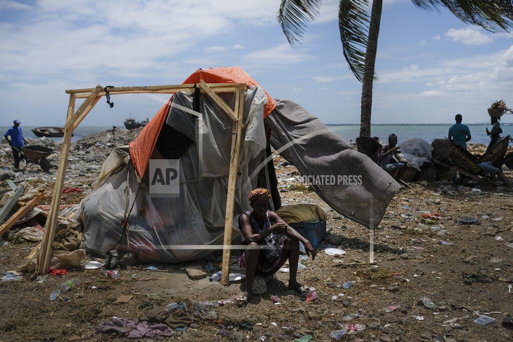 Matias Delacroix A woman sits outside her shelter in Cap-Haitien, Haiti, Thursday, July 22, 2021. The city of Cap-Haitien will hold events to honor slain President Jovenel Moïse on Thursday ahead of Friday’s funeral. (AP Photo/Matias Delacroix)