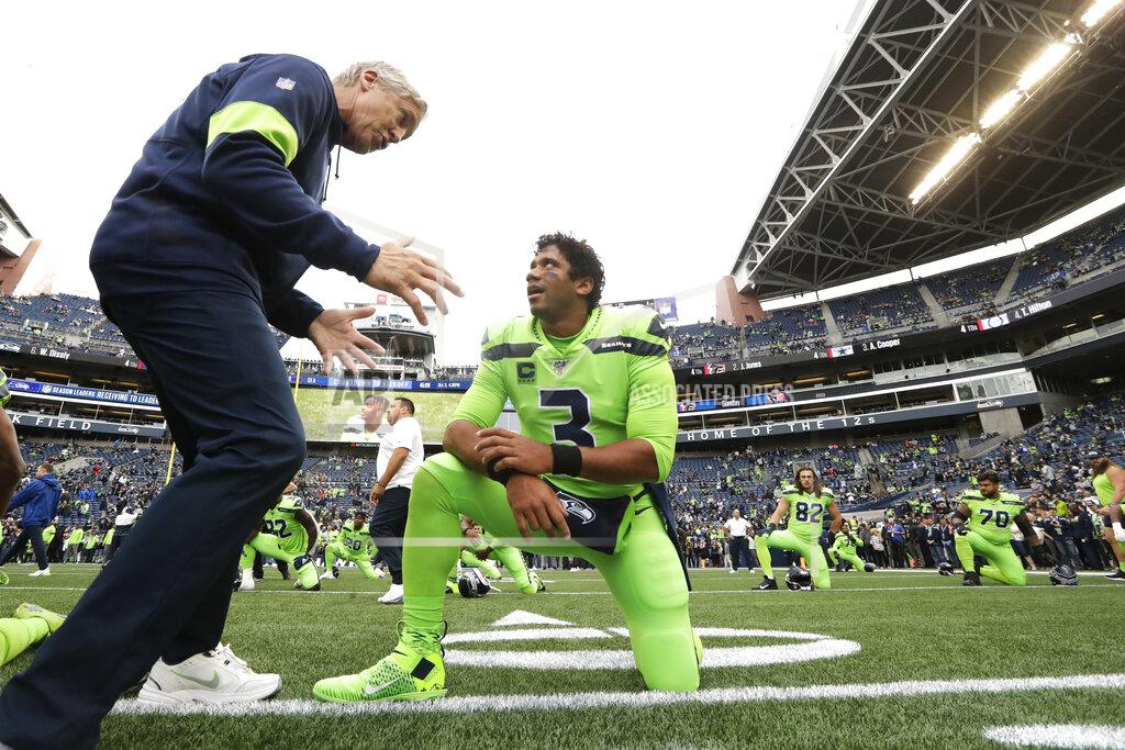 Elaine Thompson Seattle Seahawks coach Pete Carroll, left, talks with quarterback Russell Wilson during warmups for the team's NFL football game against the Los Angeles Rams, Thursday, Oct. 3, 2019, in Seattle. (AP Photo/Elaine Thompson)