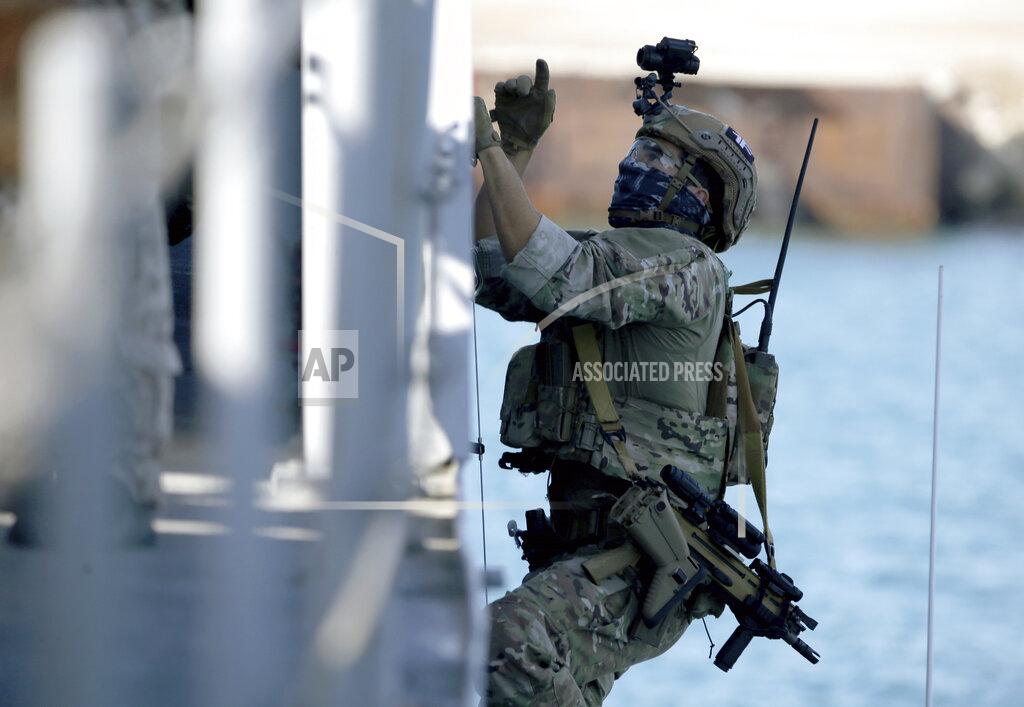 Philippos Christou A special forces operator climbs on the side of a ship during a joint U.S.-Cyprus military drill at Limassol port on Friday, Sept. 10, 2021. Cyprus' Defense Minister Charalambos Petrides said the U.S. and Cyprus are on the same strategic path to ensure security and stability in a turbulent region and that continued close cooperation between the special forces of both countries aim to counter threats from potential terrorist acts. (AP Photo/Philippos Christou)