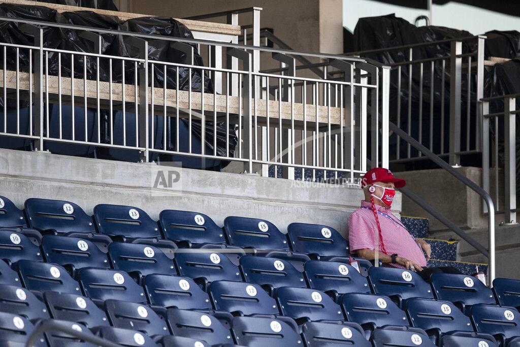 Alex Brandon Washington Nationals owner Mark Lerner wears a face mask as he sits in the stands during an exhibition baseball game against the Philadelphia Phillies at Nationals Park, Saturday, July 18, 2020, in Washington. (AP Photo/Alex Brandon)