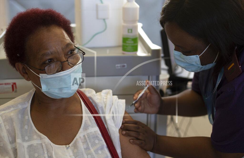 Themba Hadebe Maggie Sedidi, a 59-year-old nurse at Soweto's Chris Hani Baragwanath hospital, receives the Johnson & Johnson COVID-19 vaccine from a health staff member at a vaccination center in Soweto, South Africa, Friday, March 5, 2021. Sedidi is optimistic: "By next year, or maybe the year after, I really do hope that people will be able to begin returning to normal life." (AP Photo/Themba Hadebe)