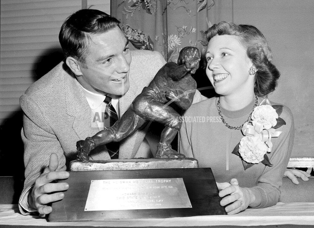 Anonymous In this Dec. 8, 1955, file photo, All-America Howard "Hopalong" Cassady, halfback for Ohio State, and his wife, Barbara, pose with the Heisman Trophy awarded to Cassady in New York. Cassady, a Heisman Trophy winner and former NFL running back, died early Friday, Sept. 20, 2019, in Tampa, Fla., Jerry Emig, the Ohio State associate athletic director said. He was 85. Cassady played both football and baseball at Ohio State in the early 1950s, winning the Heisman Trophy in 1955. He also played 10 seasons in the NFL, mostly with the Detroit, and got the nickname "Hopalong" from local sports writers after the black-hatted Western star of the 1950s. (AP Photo)