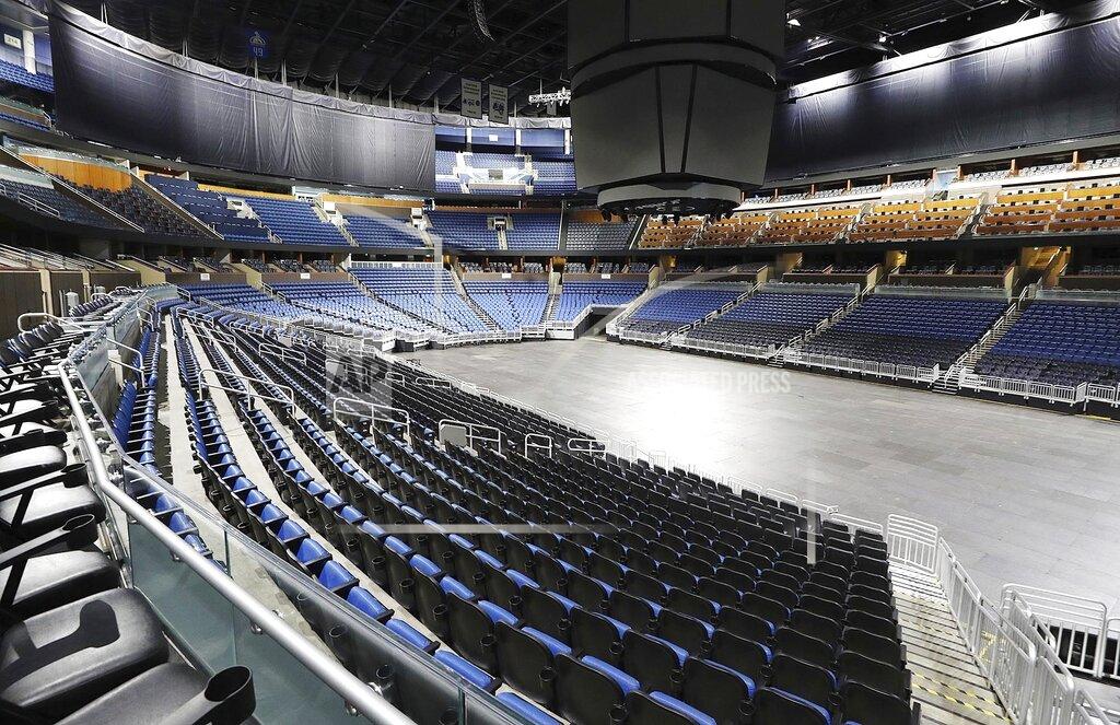 Stephen M. Dowell FILE - This is a March 12, 2020, file photo showing empty seats at the Amway Center in Orlando, home of the NBA's Orlando Magic. Most teams and leagues are reticent to discuss the fallout, but during a conference call with players, NBA commissioner Adam Silver told players that 40 percent of the league's revenue comes from ticket sales and in-arena purchases. The NBA makes about $1.2 million in gate revenue for each regular-season game played with fans, and there were 259 games remaining when the season was suspended. (Stephen M. Dowell/Orlando Sentinel via AP, File)