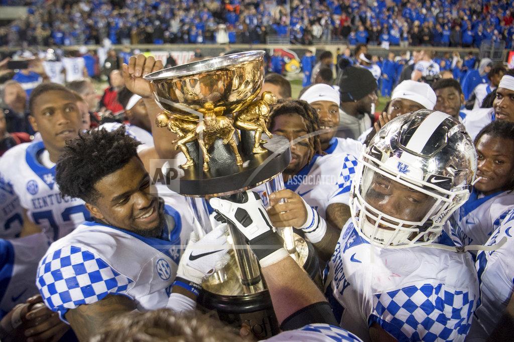Bryan Woolston Kentucky players hoist the Governor's Cup after a 56-10 win over Louisville in an NCAA college football game in Louisville, Ky., Saturday, Nov. 24, 2018. (AP Photo/Bryan Woolston)