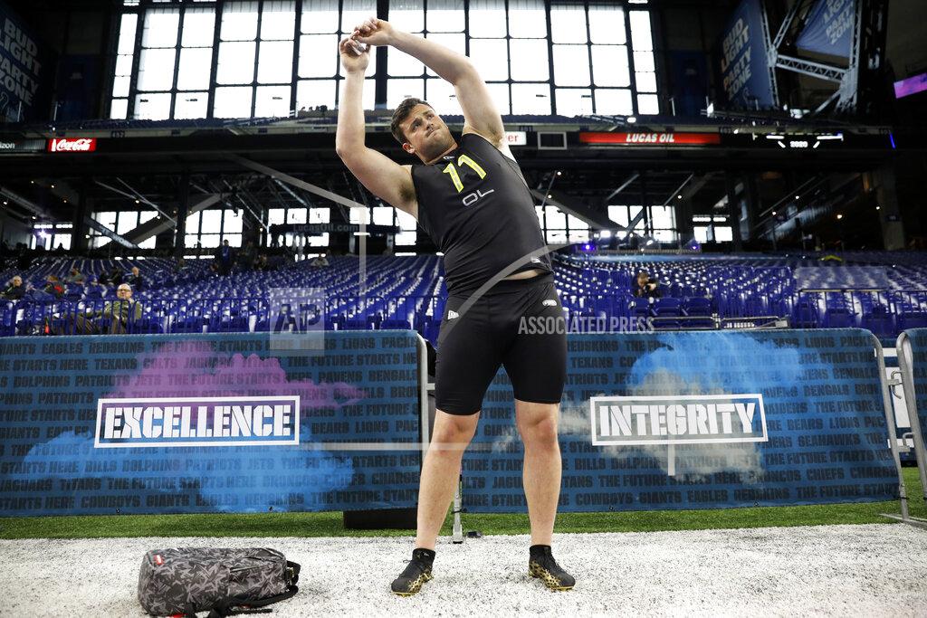 Charlie Neibergall Boise State offensive lineman Ezra Cleveland stretches at the NFL football scouting combine in Indianapolis, Friday, Feb. 28, 2020. (AP Photo/Charlie Neibergall)