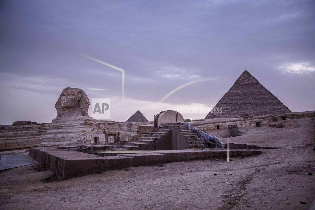Nariman El-Mofty FILE - This March 30, 2020 file photo, shows the empty Giza Pyramids and Sphinx complex on lockdown due to the coronavirus outbreak in Egypt. In July, fearing further economic fallout, the government reopened much of society and welcomed hundreds of international tourists back to resorts, even as daily reported deaths exceeded 80. Restaurants and cafes are reopening with some continued restrictions, and masks have been mandated in public. (AP Photo/Nariman El-Mofty, File)