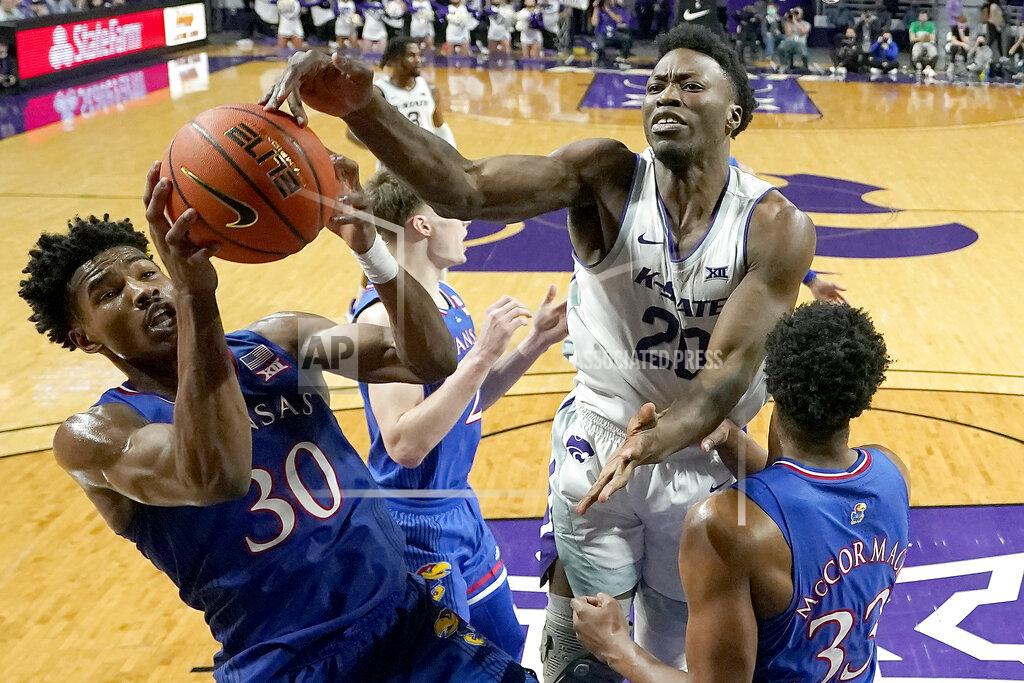 Charlie Riedel Kansas guard Ochai Agbaji (30) beats Kansas State forward Kaosi Ezeagu (20) to a rebound during the second half of an NCAA college basketball game Saturday, Jan. 22, 2022, in Manhattan, Kan. Kansas won 78-75. (AP Photo/Charlie Riedel)