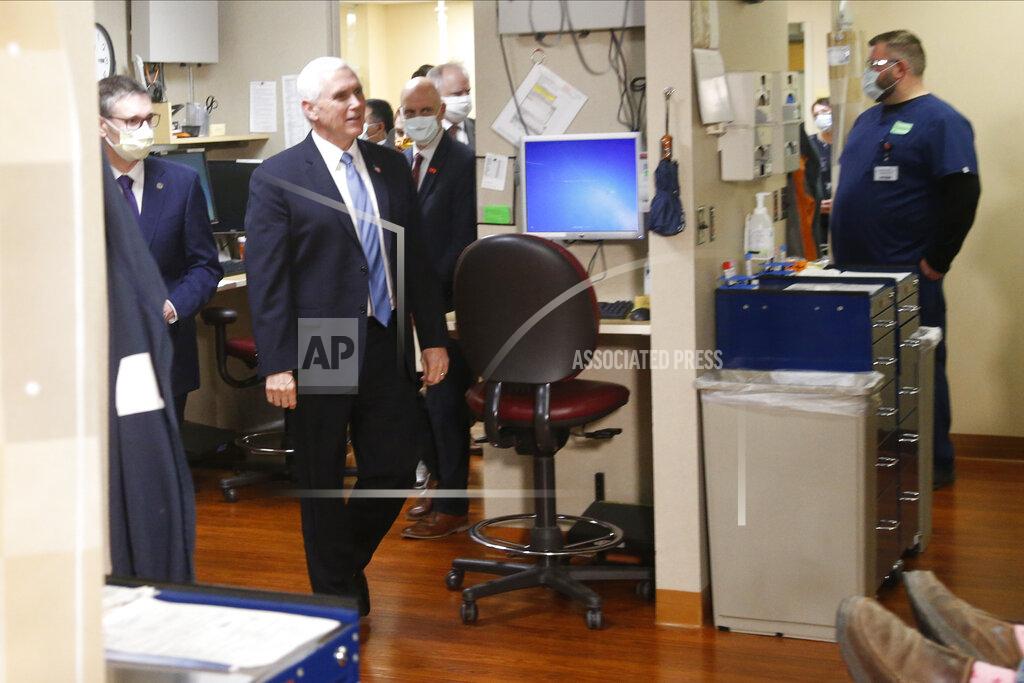 Jim Mone Vice President Mike Pence, left, visits the Mayo Clinic Tuesday, April 28, 2020, in Rochester, Minn., where he toured the facilities supporting COVID-19 research and treatment. Pence chose not to wear a face mask while touring the Mayo Clinic in Minnesota. It's an apparent violation of the world-renowned medical center's policy requiring them. (AP Photo/Jim Mone)