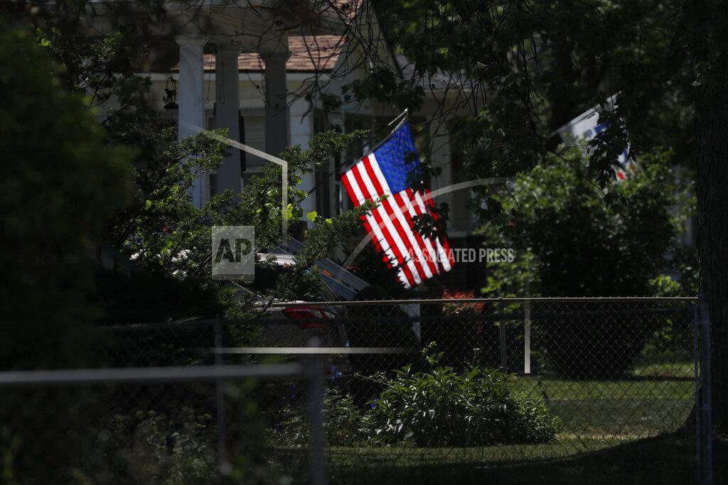 Charles Rex Arbogast A U.S. flag is lit by the midmorning sun on a neighborhood street in Saginaw, Mich., on Monday, June 29, 2020. President Donald Trump won Saginaw county by just over 1,000 votes in 2016, capitalizing on the rusting industrial city's frustrations and its dislike of Democrat Hillary Clinton. (AP Photo/Charles Rex Arbogast)