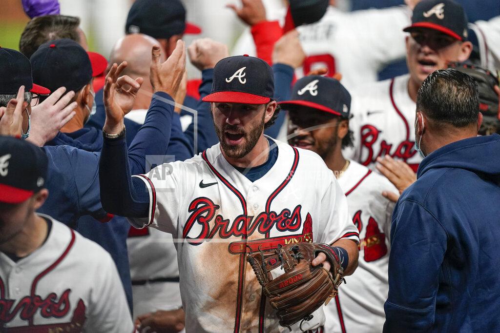 Brynn Anderson Atlanta Braves' Dansby Swanson, center, celebrates after a baseball game to clinch the NL East title against the Miami Marlins on Tuesday, Sept. 22, 2020, in Atlanta. (AP Photo/Brynn Anderson)